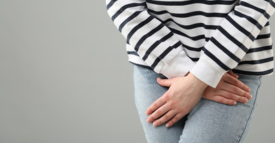 Close up of woman covering her groin.